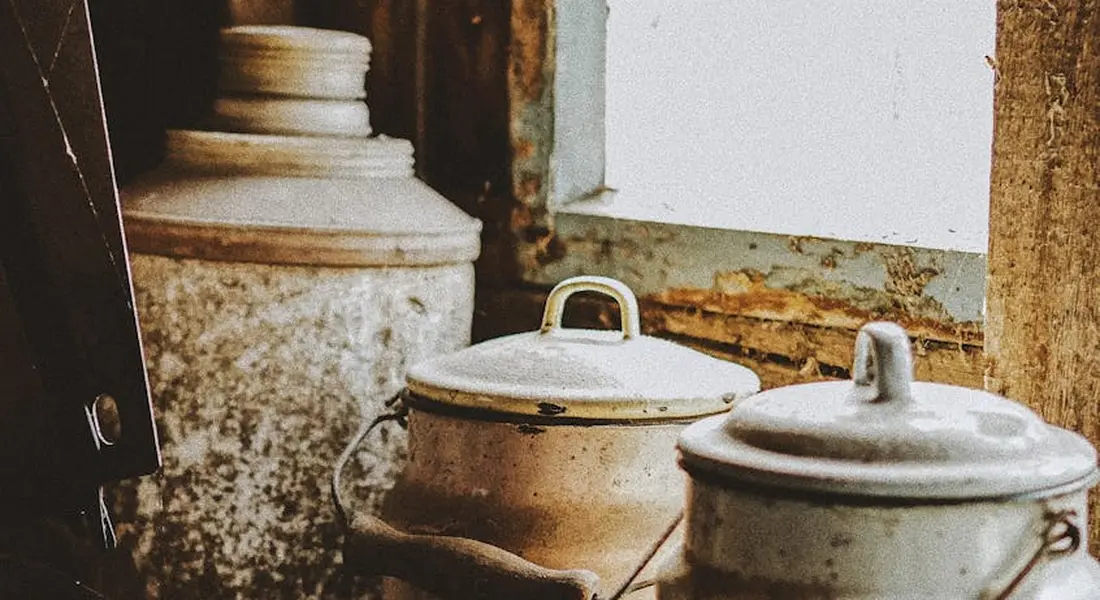 Rusty cookware and metal containers on a workbench, showing surface rust and corrosion typical of flash rust.