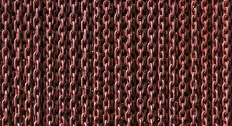 Close-up of rusted chain links showing corrosion on metal.