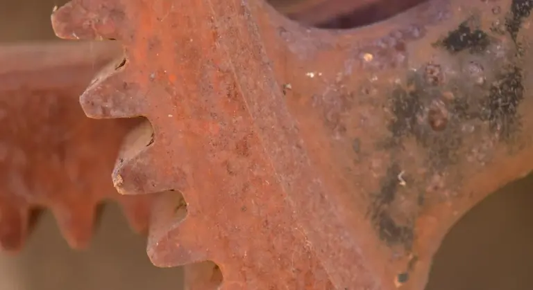 Close-up of rusted cast-iron gear teeth.