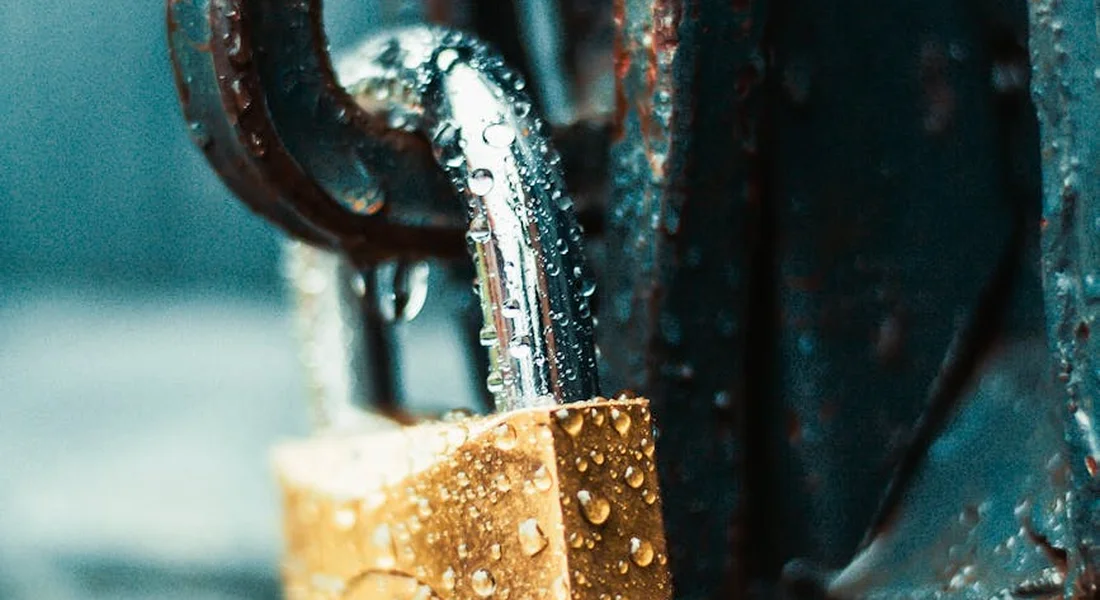Close-up of a rusted metal surface with water droplets, illustrating corrosion.
